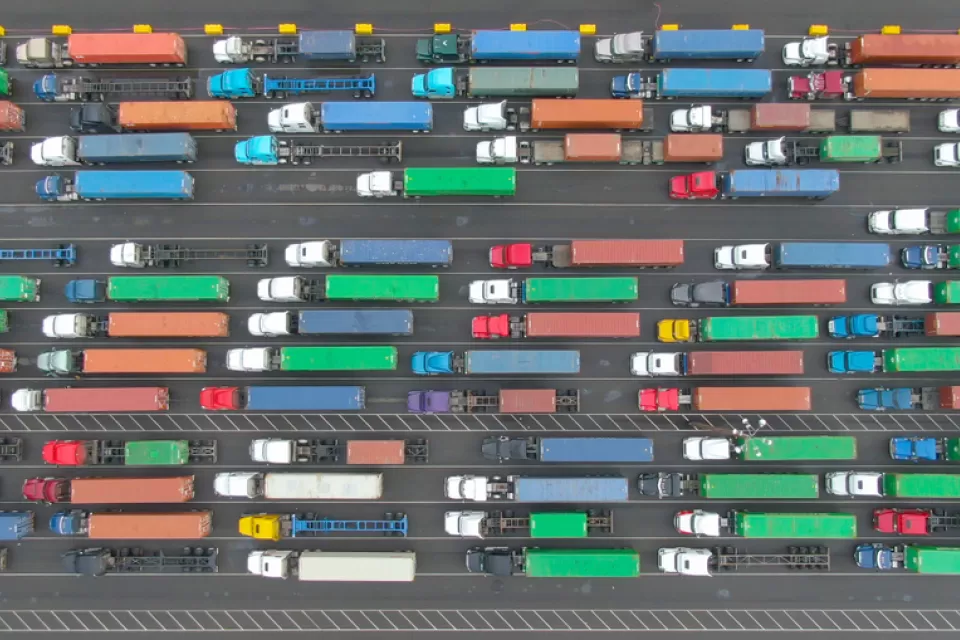 Aerial top-down view of multicolored big rig trucks in lines at the Port of Los Angeles